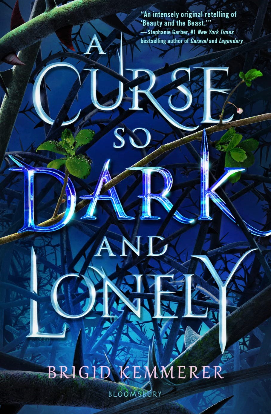 A book cover. Writing is laid over the top of a dark blue background, with twisting vines and thorns appearing to grow around and behind it. The writing, from top to bottom, is:
A review that reads: ""An intensely original retelling of 'Beauty and the Beast.'"- Stephanie Garber, #1 New York Times bestselling author of Caraval and Legendary" in light blue.
The title "A Curse So Dark And Lonely" in light and dark blue.
The authors name "Brigid Kemmerer" in pink. /end