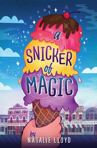A book cover. A hand holding an ice-cream cone can be seen in the foreground, against the backdrop of a town under a dark blue, cloudy sky. There are three scoops on the cone, purple at the bottom, yellow in the centre, and pink at the top, topped with a brown sauce and a cherry. The title is written on the ice cream and reads, from top to bottom:
"a" in blue, lower case lettering on the pink scoop
"snicker of" on the yellow scoop, with "snicker" in purple caps and "of" in blue
lowercase lettering
"magic" on the purple scoop, in blue caps.
At the bottom of the book, across the hand, it reads:
"by" in lowercase, blue lettering
"Natalie Lloyd" in white, capitals /end