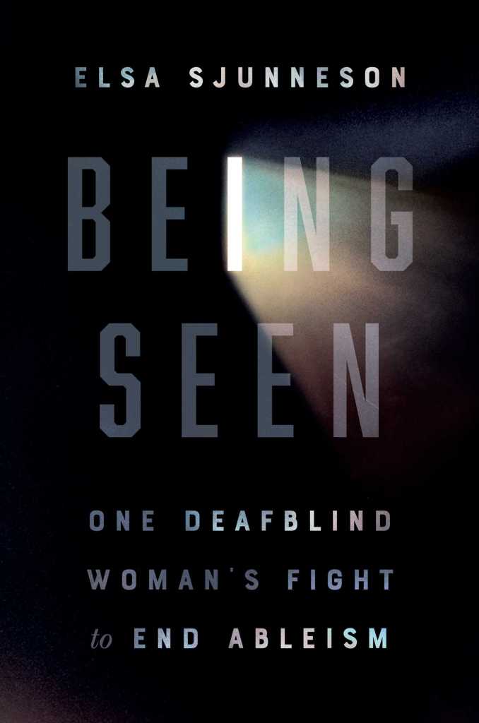 A book cover. It is a dark black with faint, grey, writing over it. The writing, from top to bottom, reads:
"Elsa Sjunneson"
"Being Seen"
"One Deafblind Woman's Fight to End Ableism"
All in capitals. The "I" in "Being Seen" is designed to look like an opening of sorts, with a ray of light coming through. /end