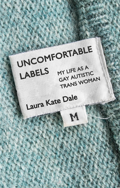 A book cover. The background is a close photograph of some kind of knitted garment, and its label. The garment is blue. The label is in the centre. Text on the label reads:
The title "Uncomfortable Labels" in large black caps
The subtitle "My Life as a Gay Autistic Trans Woman" in smaller black caps, lower left of this
The author's name "Laura Kate Dale" at the bottom of the label in black writing. 
A smaller label attached to the bottom has a single, black capitalised "M" written on it. /end