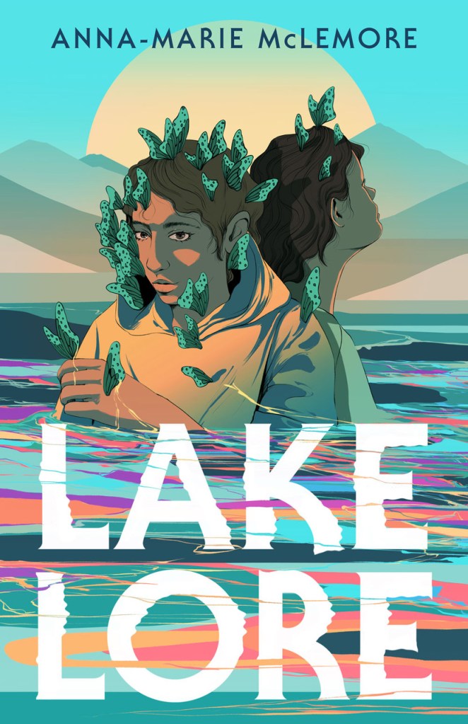 A book cover. The author's name "Anna-Marie McLemore" is written at the top in dark blue caps. The title "Lakelore" is written at the bottom in larger white caps. The background shows two young people stood in a body of water. The water goes past their elbows. Both are wearing a yellow garment and have dark brown hair. A lot of blue butterflies are sat on them. The water is a colourful mix of purple, blue, green, orange and red. Behind the people, a large sun behind some faint mountain ranges. /end