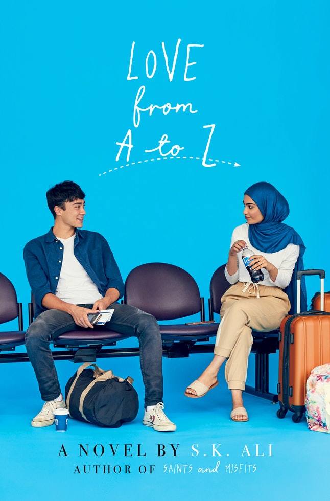 A book cover. The title "Love from A to Z" is written in white at the top. "Love", "A" and "Z" are capitalised. "From" and "to" are written in lowercase cursive. Text at the bottom reads "A novel by S. K. Ali". "A Novel By" is written in black caps. The author's name is written in white caps. Below this, in smaller writing, text reads "Author of Saints and Misfits". "Author of" is written in black caps. The book title is written in white caps. The background is light blue. In the bottom half of the cover, a young man and woman sat on a row of fold out seats. The man has short black hair and is wearing a white t-shirt, blue overshirt, grey jeans and white shoes. A duffel bag is between his feet. The girl is wearing a dark blue hijab, a white long sleeved shirt, beige pants and white and beige sandals. An orange suitcase is to her left. /end