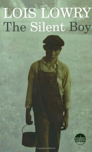A book cover. The author's name "Lois Lowry" is written at the top in large white capitals. The title "The Silent Boy" is written directly below this in slightly smaller capitals. "The" and "Boy" are in black lettering. "Silent" is in white lettering. The background is dark and shows a photograph of a young boy holding a bucket in his right hand in the foregrounds. The boy is wearing a cap, and dark overalls over a lighter long-sleeved shirt. /end