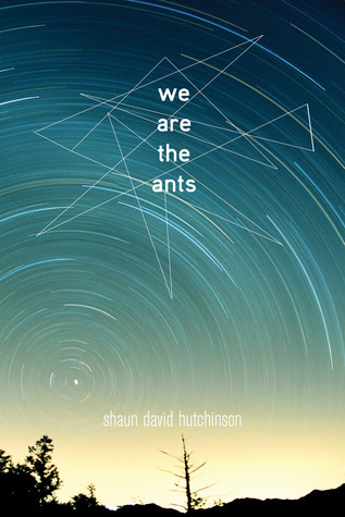 A book cover. The title "We Are the Ants" is written vertically down the centre of the upper half of the cover, in lowercase white writing. The author's name "Shaun David Hutchinson" is written at the bottom of the cover in very small, white lowercase lettering. The background shows a sky of various shades of blue above the dark silhouettes of trees. A lot of white and blue lines are around the sky, forming a circle in the lower left corner that ripples out to the upper right corner. Around the title, white lines that zig-zag to form various triangles of different sizes. /end
